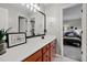 Bright bathroom featuring modern vanity with drawers and a decorative mirror with views to bedroom at 3020 Imperial Oaks Dr, Raleigh, NC 27614