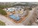 Aerial view of the community's pool, tennis courts, clubhouse, and parking lot at 3020 Imperial Oaks Dr, Raleigh, NC 27614