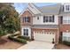 Exterior view of a red brick home with manicured landscaping and a two-car garage at 3020 Imperial Oaks Dr, Raleigh, NC 27614