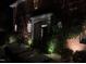 Home exterior featuring a covered front porch, brick facade, and decorative landscaping with subtle lighting at 3020 Imperial Oaks Dr, Raleigh, NC 27614
