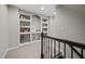 Upstairs hallway with decorative shelves and neutral carpet, illuminated by recessed lighting at 3020 Imperial Oaks Dr, Raleigh, NC 27614