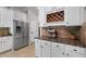 Kitchen showcasing stainless steel refrigerator, granite countertops, and white cabinetry at 3020 Imperial Oaks Dr, Raleigh, NC 27614