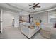 Inviting living room leads into a main bedroom featuring a tray ceiling and neutral color palette at 3020 Imperial Oaks Dr, Raleigh, NC 27614