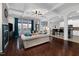 Bright living room featuring coffered ceilings, a fireplace and hardwood floors adjacent to the modern kitchen at 3020 Imperial Oaks Dr, Raleigh, NC 27614
