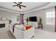 Cozy living room features a tray ceiling, a decorative fireplace, and ample natural light from the large windows at 3020 Imperial Oaks Dr, Raleigh, NC 27614