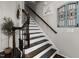 Staircase with dark wood railings and white risers, enhanced by stylish decor and a modern touch at 3020 Imperial Oaks Dr, Raleigh, NC 27614
