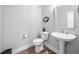 Elegant powder room with a pedestal sink, modern fixtures, and stylish decor at 315 E Fourth St, Wendell, NC 27591