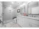 Modern bathroom with double sinks, a walk-in shower, and bright lighting at 315 E Fourth St, Wendell, NC 27591