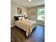 Charming bedroom with wood floors and large window at 315 E Fourth St, Wendell, NC 27591