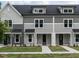 Three-unit townhome building, gray siding, white trim, and dark roofs at 315 E Fourth St, Wendell, NC 27591