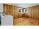 Dedicated laundry room with wood paneling and hardwood floors at 3237 Birnamwood Rd, Raleigh, NC 27607