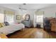 Spacious bedroom with hardwood floors, a desk, and ample storage at 3305 Landor Road Rd, Raleigh, NC 27609