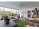 Relaxing screened porch with outdoor furniture and artificial turf at 3305 Landor Road Rd, Raleigh, NC 27609