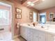 Double vanity bathroom with pink wallpaper and shower at 3500 Chaucer Pl, Raleigh, NC 27609