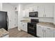 Kitchen boasting black appliances and white cabinets at 358 Pillow Ln, Burlington, NC 27217