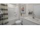 Clean bathroom with a tub shower, white vanity, and neutral decor at 3605 Sorda Ct, Raleigh, NC 27610
