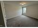 Bright bedroom with grey carpet and window at 3732 Massey Pond Trl, Raleigh, NC 27616