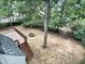 Spacious backyard with wooden deck, mature trees and a fire pit at 408 Froyle Ct, Rolesville, NC 27571
