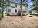 A white home with a wooden deck and a backyard with straw on the grass at 408 Froyle Ct, Rolesville, NC 27571
