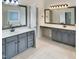 Bathroom boasts double vanities, updated lighting, and a separate tub and shower at 408 Froyle Ct, Rolesville, NC 27571