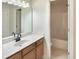 Bright bathroom featuring a vanity with solid surface countertops and a shower over tub at 408 Froyle Ct, Rolesville, NC 27571