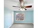 Charming bedroom with light blue walls, ceiling fan and large window at 408 Froyle Ct, Rolesville, NC 27571