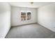 Simple bedroom with carpeted floors and a large window at 408 Froyle Ct, Rolesville, NC 27571