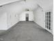 Large bonus room with two sets of french doors and neutral carpeting at 408 Froyle Ct, Rolesville, NC 27571