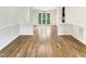 Spacious dining room featuring hardwood floors, wainscoting and large window at 408 Froyle Ct, Rolesville, NC 27571