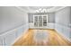 Bright dining room with hardwood floors, wainscoting, and large windows at 408 Froyle Ct, Rolesville, NC 27571