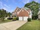 Charming two-story brick home with a well-manicured lawn and attached two-car garage at 408 Froyle Ct, Rolesville, NC 27571