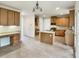 Open-concept kitchen features light-wood cabinets and a stone countertop island at 408 Froyle Ct, Rolesville, NC 27571