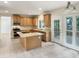 This kitchen features an island, light-wood cabinets and stone countertops at 408 Froyle Ct, Rolesville, NC 27571