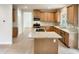 This kitchen has a center island, stainless steel appliances and light-wood cabinets at 408 Froyle Ct, Rolesville, NC 27571
