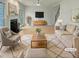 Bright living room featuring a fireplace, hardwood floors, and stylish neutral furniture at 408 Froyle Ct, Rolesville, NC 27571