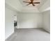 Spacious main bedroom with a tray ceiling, ceiling fan, and neutral carpeting at 408 Froyle Ct, Rolesville, NC 27571