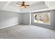 Spacious main bedroom with a ceiling fan and ample natural light at 408 Froyle Ct, Rolesville, NC 27571