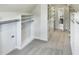 Large walk-in closet with custom shelving and drawers for organized storage at 408 Froyle Ct, Rolesville, NC 27571