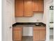 Convenient wet bar area with wood cabinets, sink, and granite countertop at 408 Froyle Ct, Rolesville, NC 27571