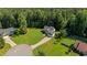 Aerial view of house surrounded by mature trees and a well-manicured lawn at 46 Trusting Ln, Middlesex, NC 27557