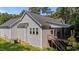 Back of home featuring a large screened in porch and a wooden deck with stairs to the backyard at 46 Trusting Ln, Middlesex, NC 27557
