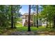 View of the backyard featuring a screened porch with stairs and lush green grass at 46 Trusting Ln, Middlesex, NC 27557