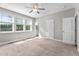 A bright bedroom with carpet, neutral walls, a ceiling fan, and windows that bring in natural light at 46 Trusting Ln, Middlesex, NC 27557