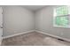 A cozy bedroom with carpet flooring, a single window, and a closet with double doors at 46 Trusting Ln, Middlesex, NC 27557