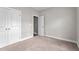 A bedroom with neutral walls, carpet, closet, and door creates a cozy and functional space at 46 Trusting Ln, Middlesex, NC 27557