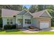 Charming single Gathering home featuring a brick and vinyl exterior, attached two car garage, and well maintained lawn at 46 Trusting Ln, Middlesex, NC 27557