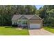 Charming single Gathering home featuring a brick and vinyl exterior, attached two car garage, and well maintained lawn at 46 Trusting Ln, Middlesex, NC 27557