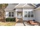 Front entrance of a house featuring gray siding and a white door at 46 Trusting Ln, Middlesex, NC 27557