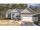Gray siding two-story house with a white door and attached two-car garage at 46 Trusting Ln, Middlesex, NC 27557