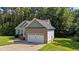 Charming single Gathering home featuring a brick and vinyl exterior, attached two car garage, and well maintained lawn at 46 Trusting Ln, Middlesex, NC 27557